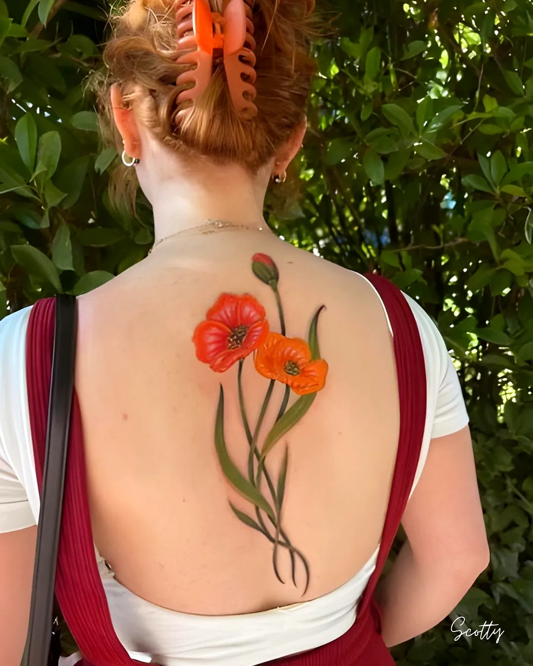 Vibrant Orange Flower Upper Back Tattoo