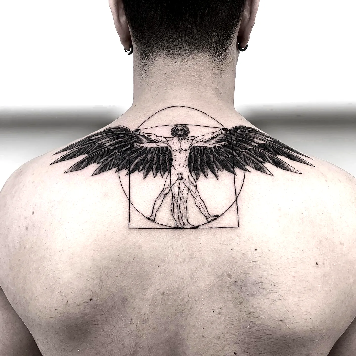 Vitruvian Man Upper Back Tattoo