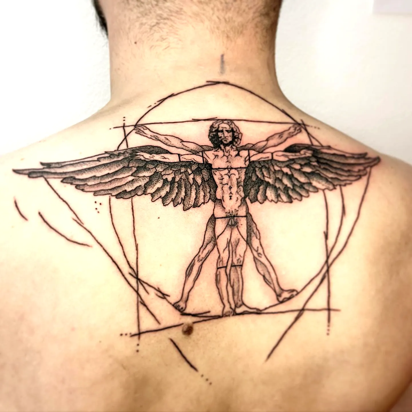 Vitruvian Man Wings Upper Back Tattoo