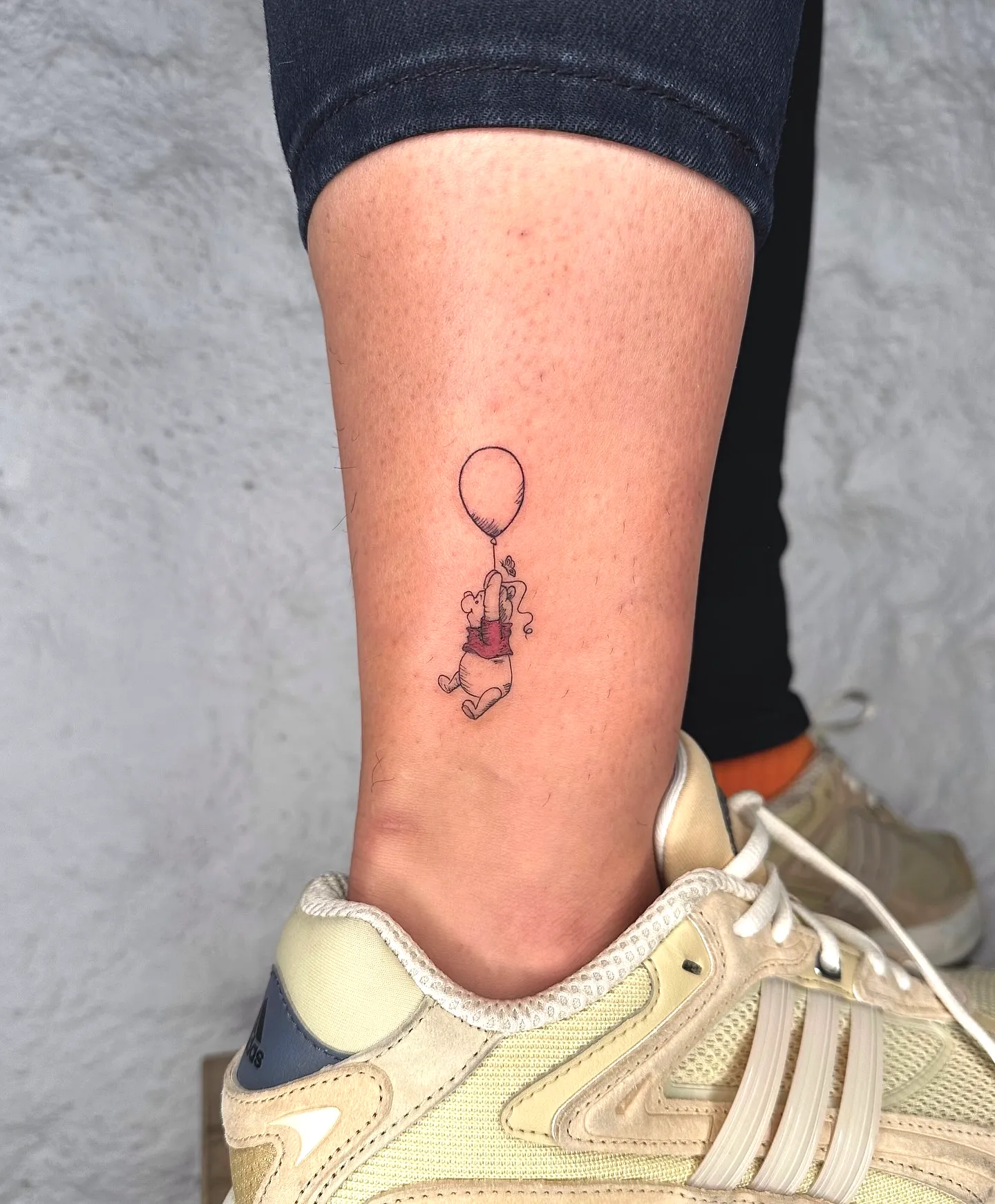 Whimsical Balloon Figure Ankle Tattoo