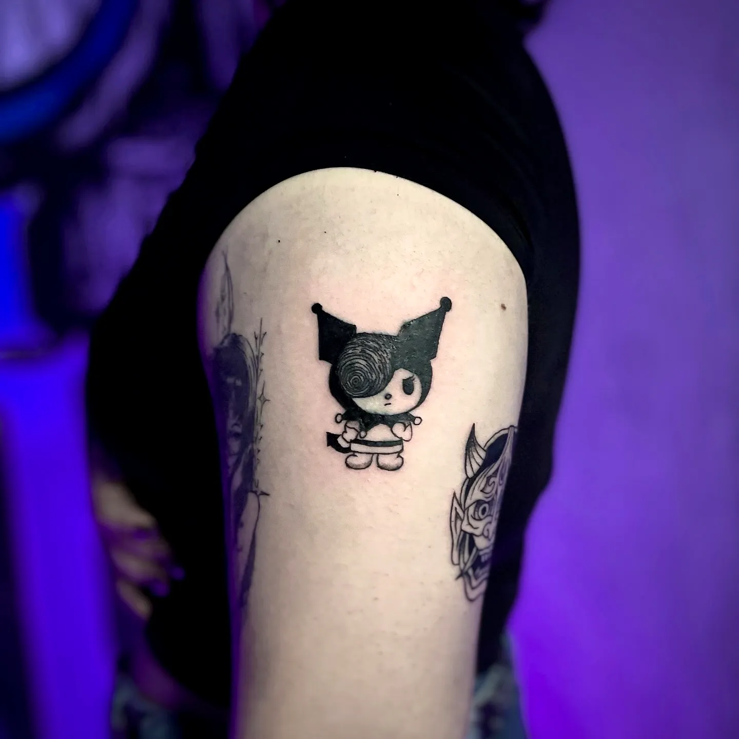 Whimsical Character Upper Arm Tattoo