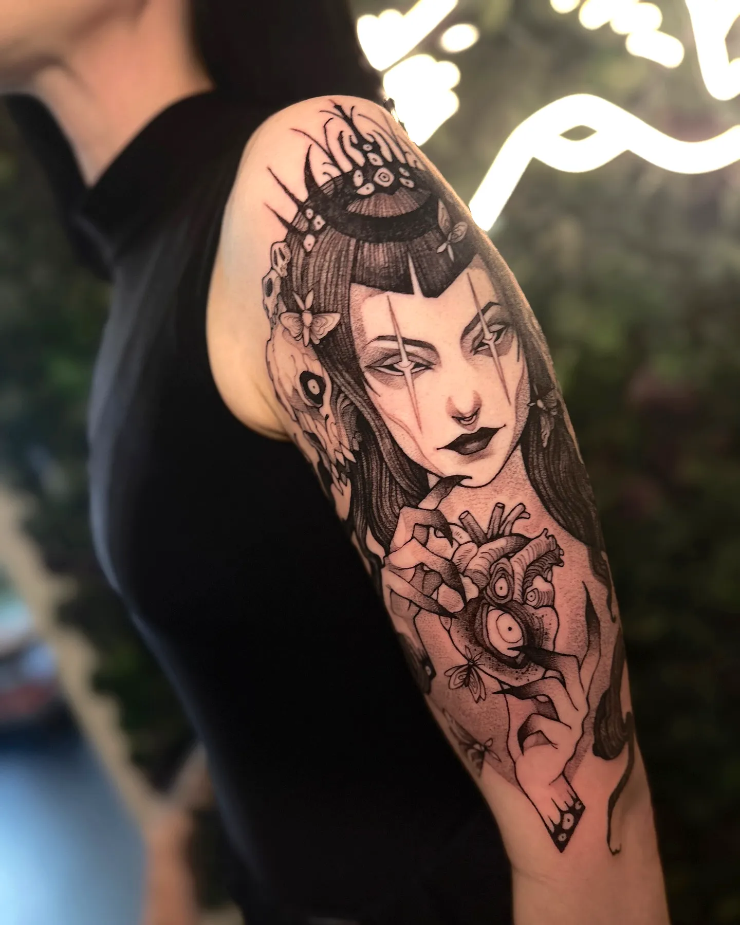 Woman crown heart upper arm tattoo