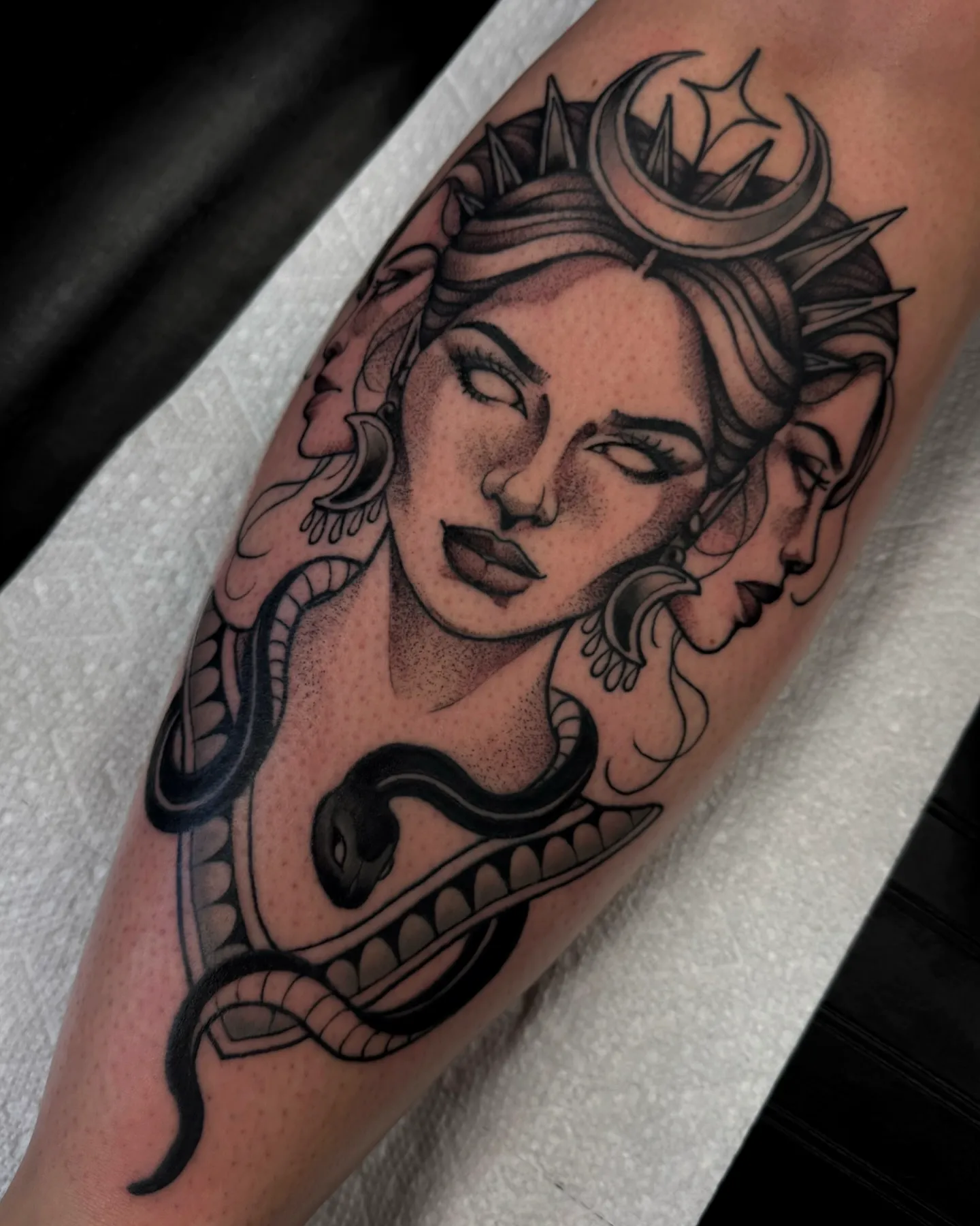 womans face arm tattoo with snake