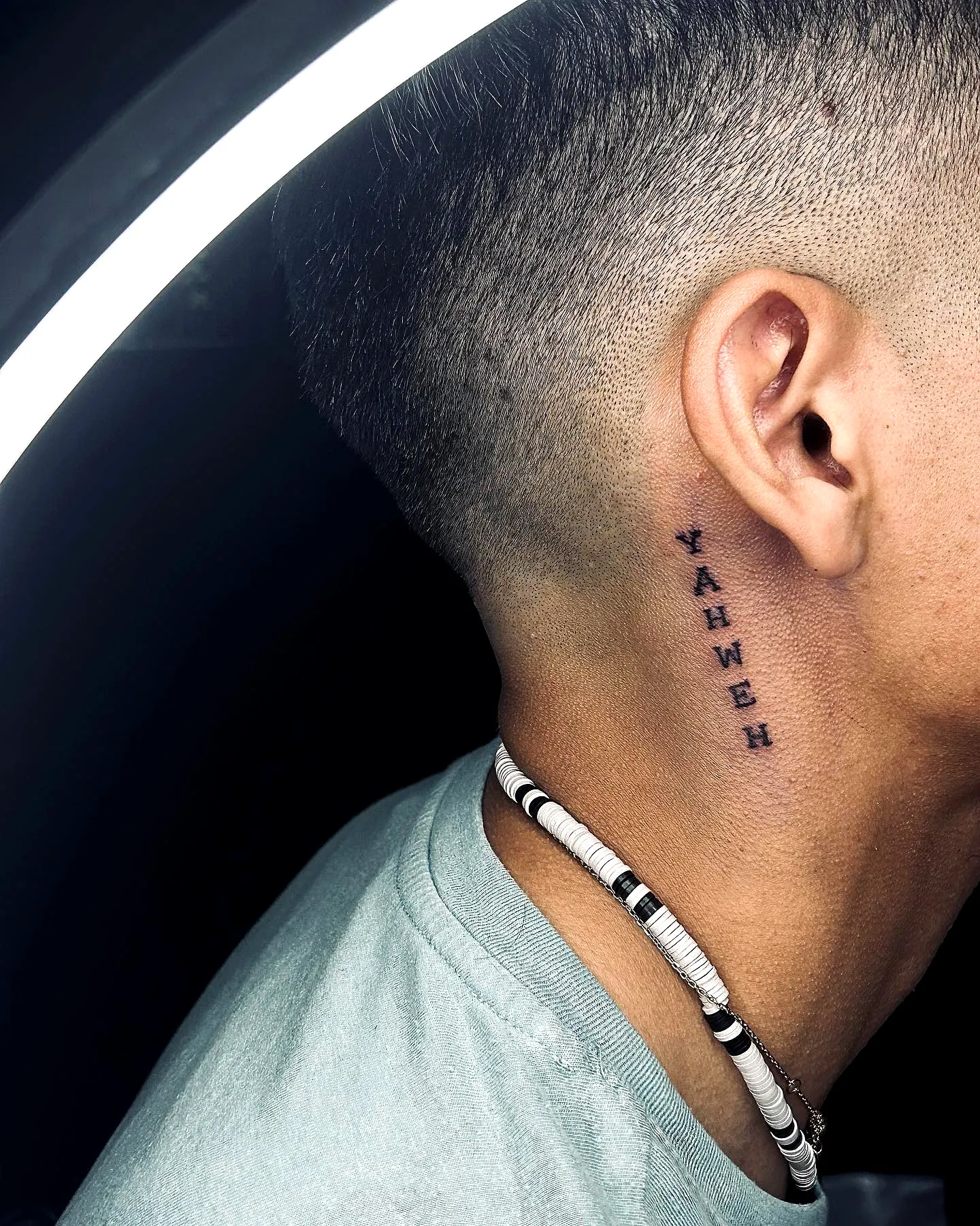 Yahweh Neck Tattoo in Bold Black Ink