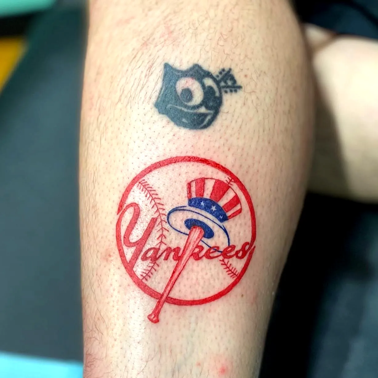 Yankees logo leg tattoo with rose